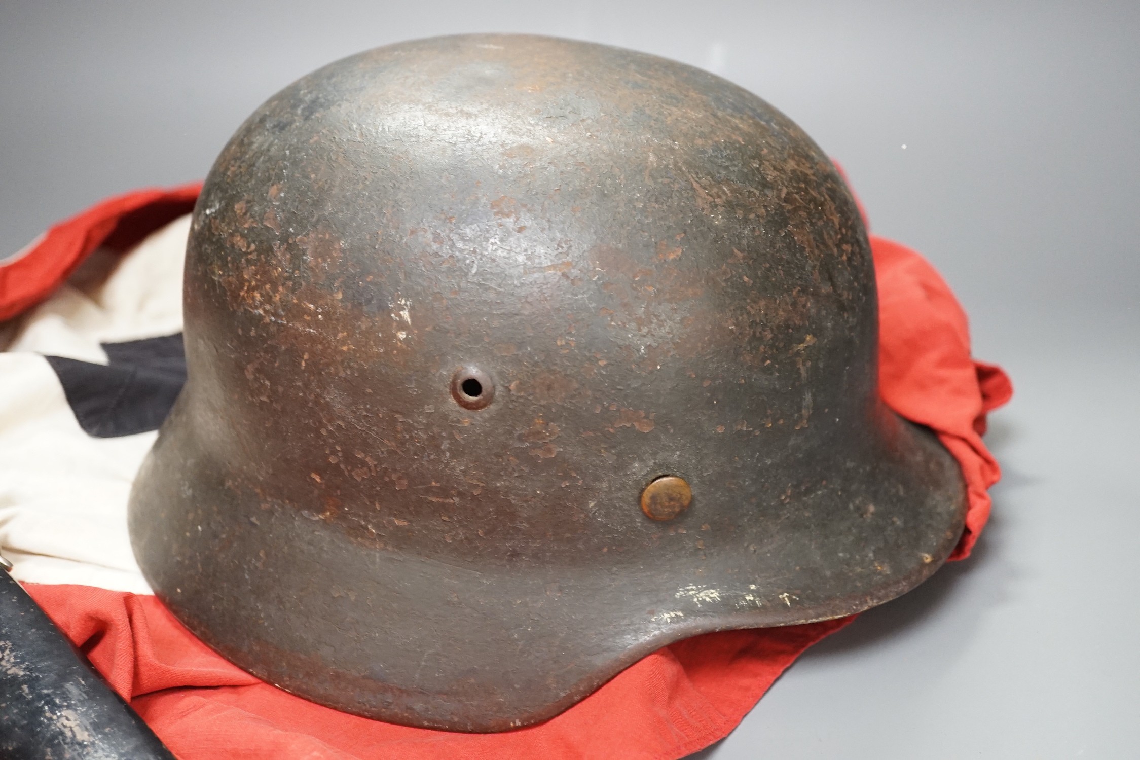 A Third Reich SS dagger, German steel helmet and a Nazi flag